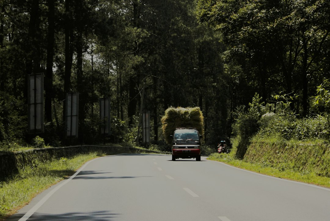Mobil melaju di jalan raya, ilustrasi perjalanan darat dengan mobil travel Medan-Pekanbaru