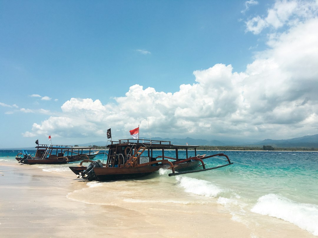 Perahu kayu di tepi pantai, gambaran suasana pesisir yang dituju dengan mobil travel Medan-Sibolga